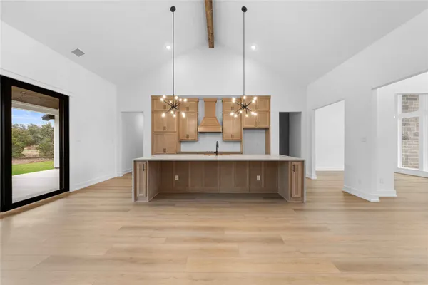 a view of a kitchen with a sink and a refrigerator