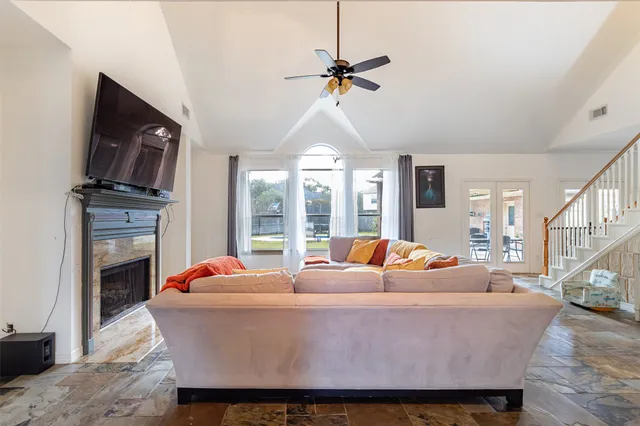 a living room with furniture a fireplace and a flat screen tv