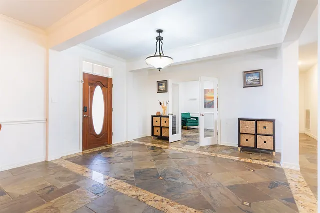 a view of a hallway with a chandelier and livingroom