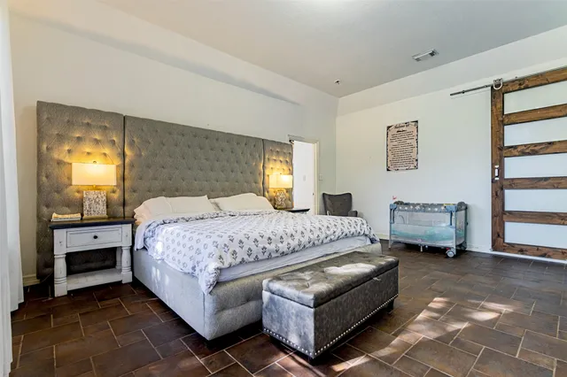 a bedroom with a bed and a couch