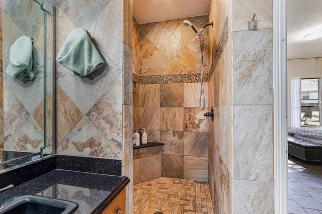 a bathroom with a shower and a sink