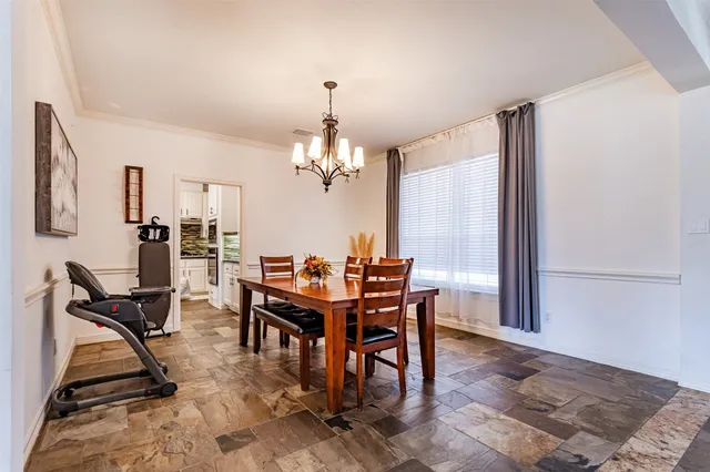 a view of a dining room with furniture and window