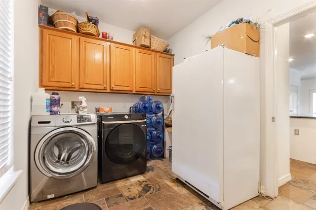 a utility room with sink dryer and washer