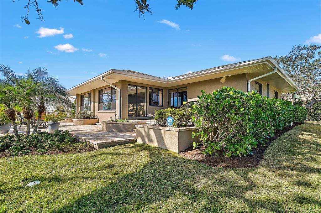641 Bayshore Road Nokomis, FL 34275 - Photo 12 of 63 a front view of a house with garden