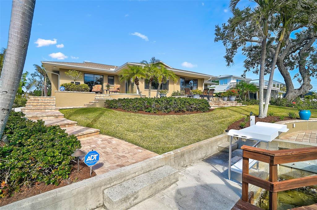 641 Bayshore Road Nokomis, FL 34275 - Photo 16 of 63 a front view of a house with garden