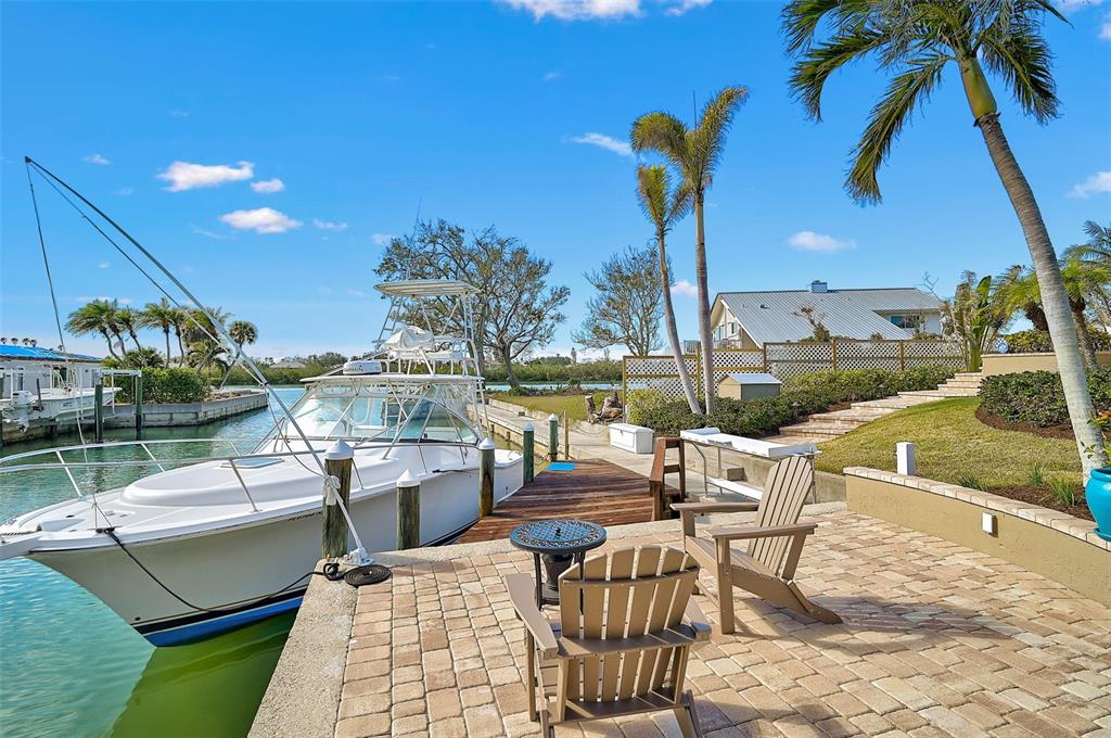 641 Bayshore Road Nokomis, FL 34275 - Photo 18 of 63 a view of a patio with couches potted plants and a table