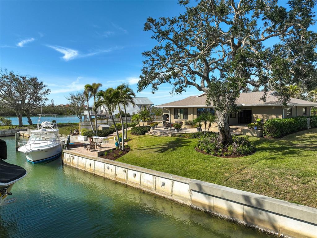 641 Bayshore Road Nokomis, FL 34275 - Photo 22 of 63 a view of a house with a yard patio and fire pit