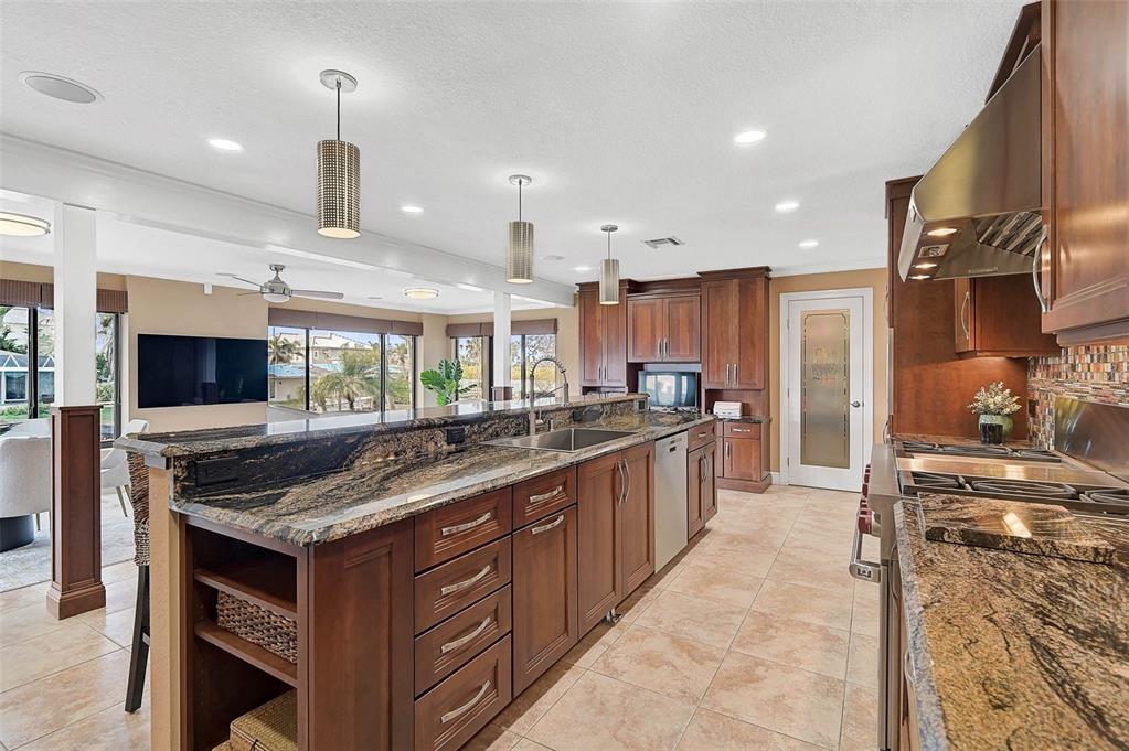 641 Bayshore Road Nokomis, FL 34275 - Photo 29 of 63 a kitchen with stainless steel appliances granite countertop a stove and a sink