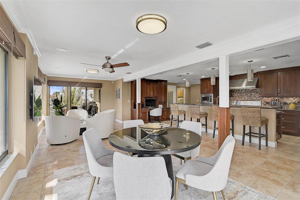 641 Bayshore Road Nokomis, FL 34275 - Photo 31 of 63 a living room with furniture a table and kitchen view