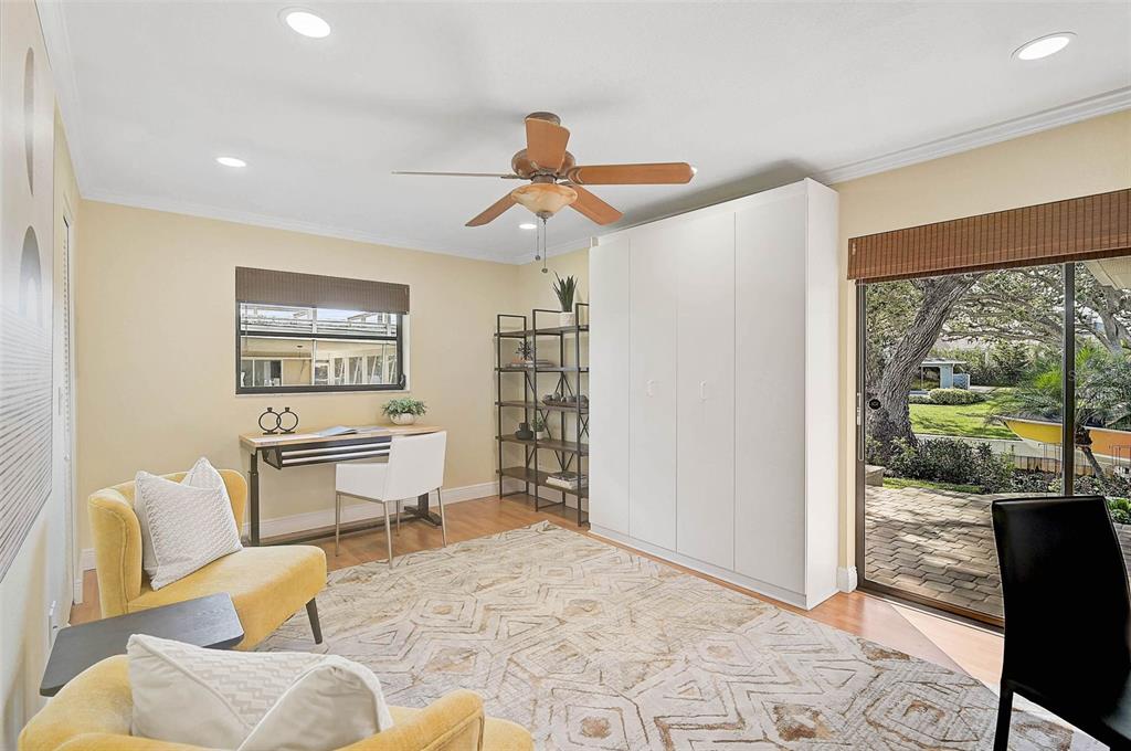 641 Bayshore Road Nokomis, FL 34275 - Photo 43 of 63 a living room with furniture a lamp and a floor to ceiling window