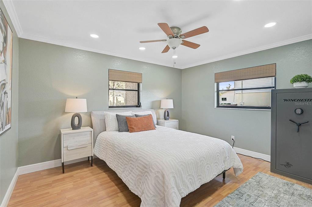 641 Bayshore Road Nokomis, FL 34275 - Photo 45 of 63 a bedroom with a large bed and a chandelier