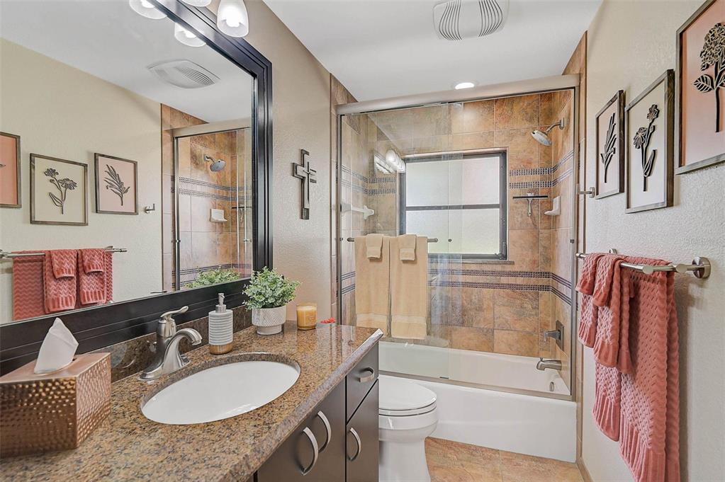 641 Bayshore Road Nokomis, FL 34275 - Photo 46 of 63 a bathroom with a granite countertop sink toilet and shower