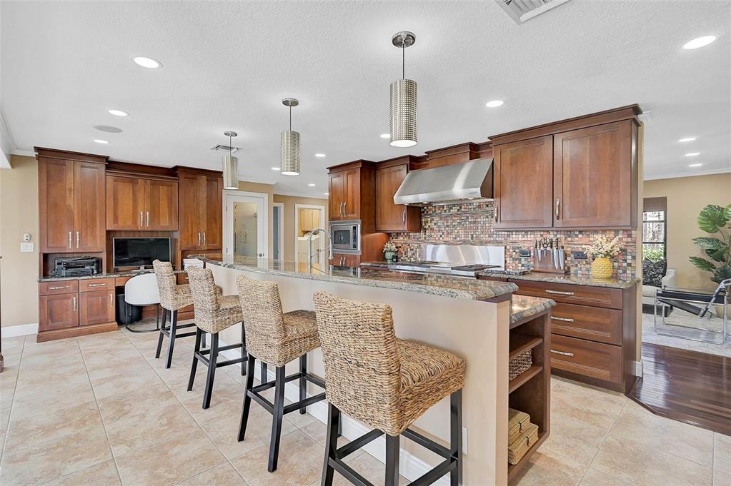 641 Bayshore Road Nokomis, FL 34275 - Photo 5 of 63 a kitchen with kitchen island granite countertop wooden cabinets and a view of living room