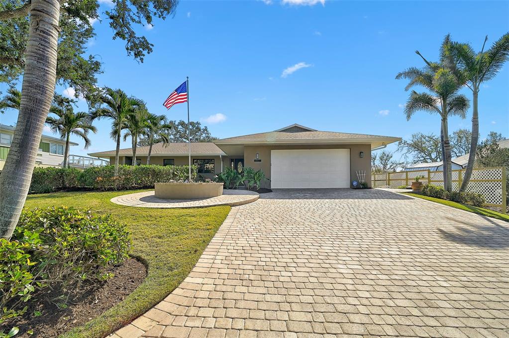 641 Bayshore Road Nokomis, FL 34275 - Photo 6 of 63 a front view of a house with garden