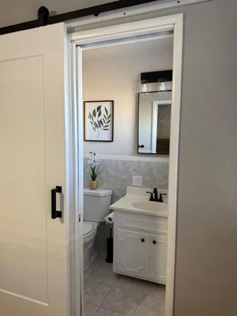 a bathroom with a sink mirror and toilet