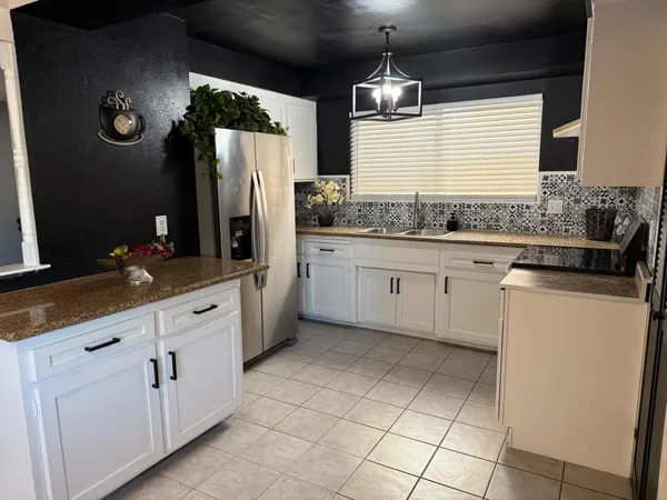a kitchen with a sink stove and cabinets