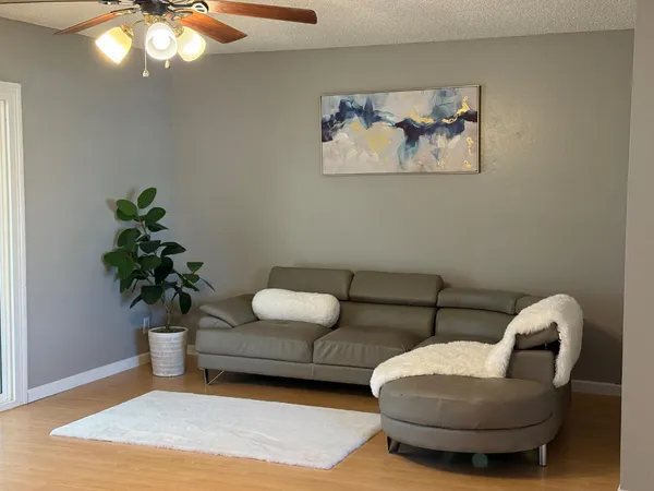 a living room with furniture and a potted plant