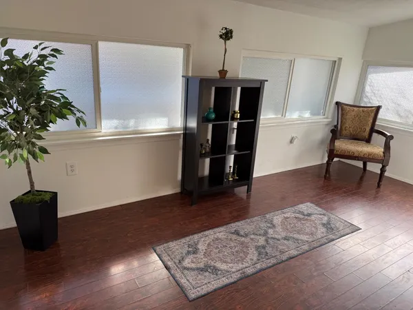 a living room with furniture and a potted plant