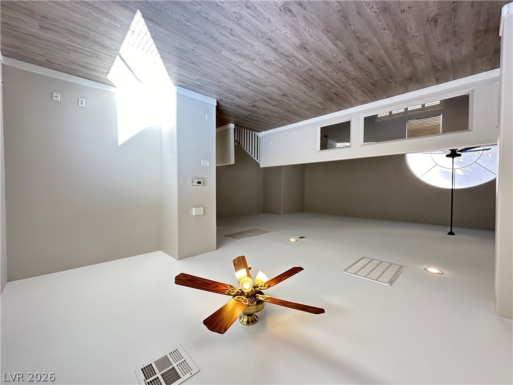 10191 Splendor Ridge Avenue Las Vegas, NV 89135 - Photo 16 of 31 A living space offers a ceiling fan, recessed lighting, and a unique semicircular window.