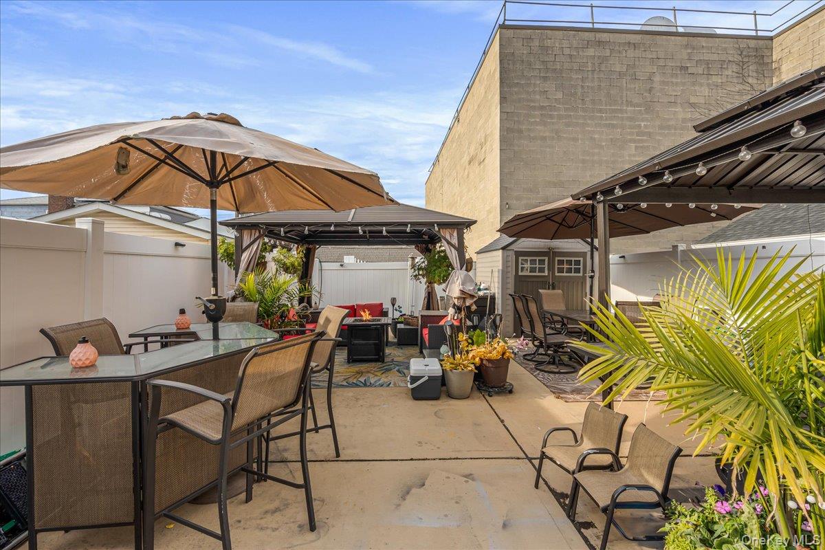 14428 158th Street Queens, NY 11434 - Photo 17 of 17 a view of a patio with table and chairs and potted plants