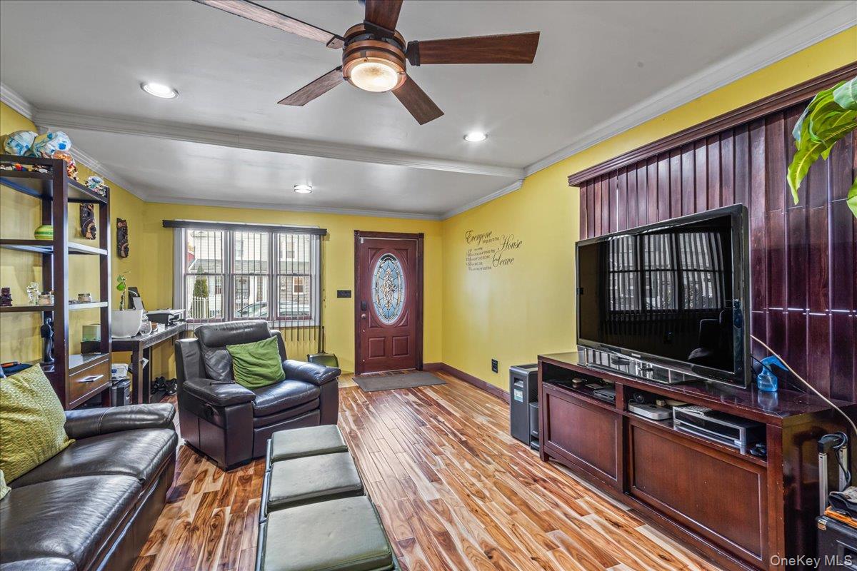 14428 158th Street Queens, NY 11434 - Photo 3 of 17 a living room with furniture a flat screen tv and floor to ceiling window