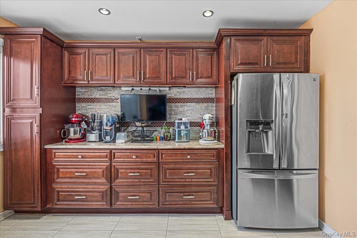14428 158th Street Queens, NY 11434 - Photo 8 of 17 a kitchen with stainless steel appliances granite countertop a refrigerator and cabinets