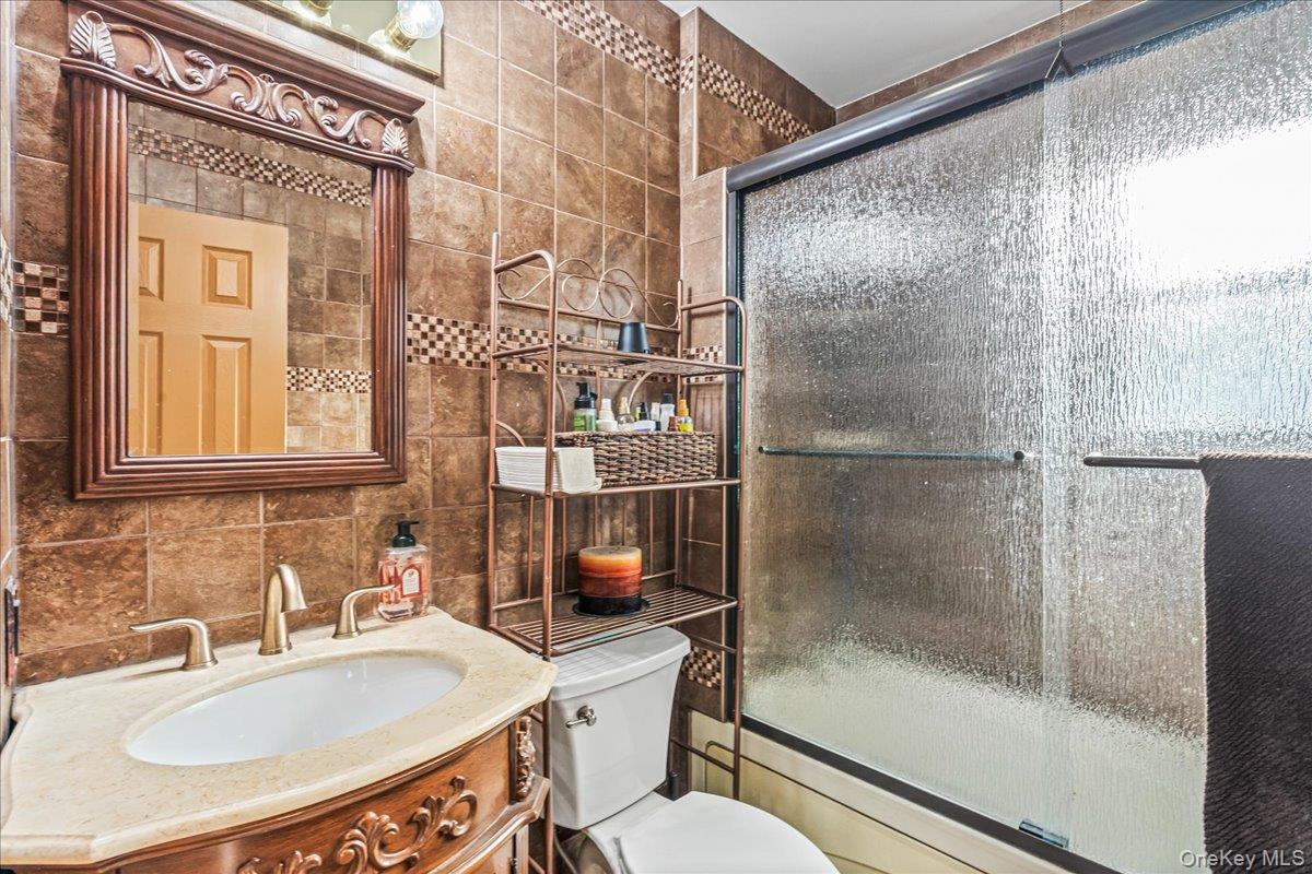 14428 158th Street Queens, NY 11434 - Photo 9 of 17 a bathroom with a sink toilet and shower