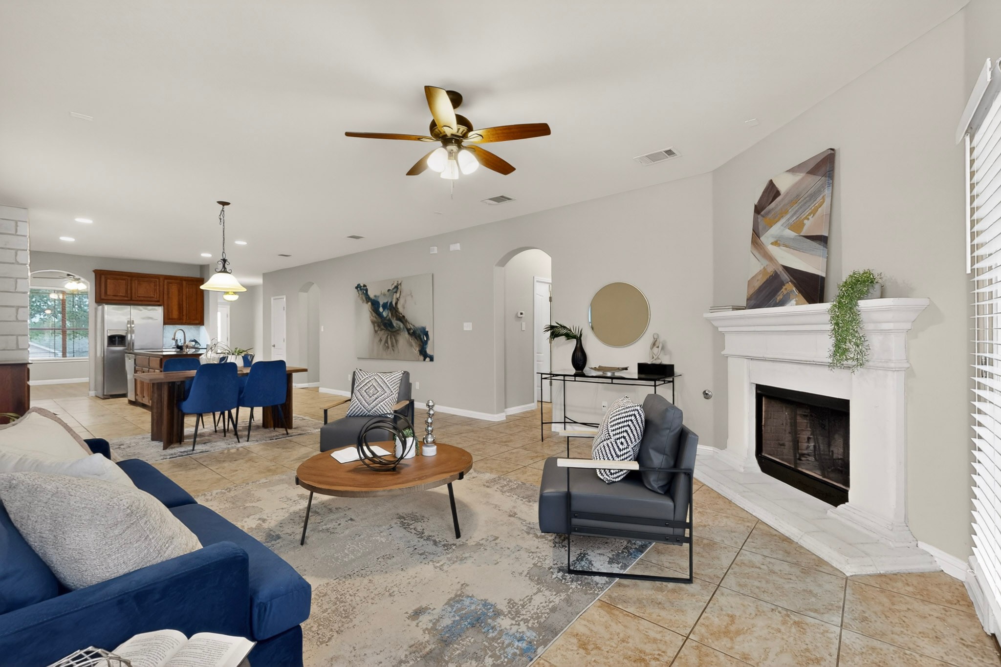 178 Limestone Trail Austin, TX 78737 - Photo 11 of 40 Open-concept living area featuring a fireplace with a white mantel, tile flooring, and a ceiling fan