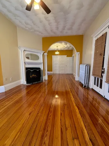 a view of empty room with wooden floor