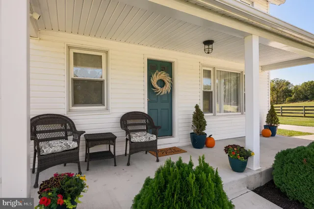 a kitchen with stainless steel appliances a refrigerator a sink and white cabinets