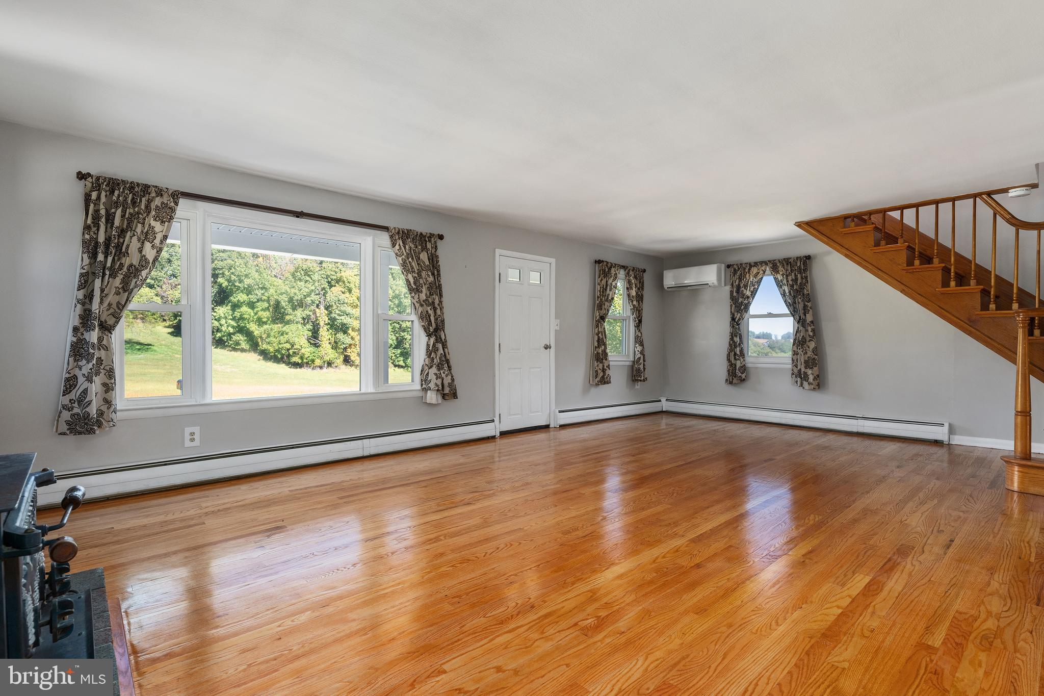 16357 Trenton Road Upperco, MD 21155 - Photo 15 of 68 a view of an empty room with wooden floor and a window