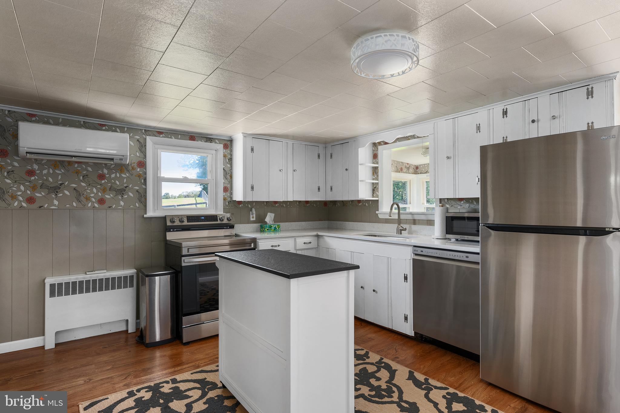 16357 Trenton Road Upperco, MD 21155 - Photo 20 of 68 a kitchen with stainless steel appliances a refrigerator a sink and white cabinets