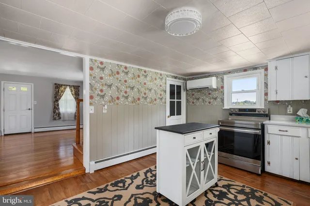 a view of a hallway with wooden floor and stairs