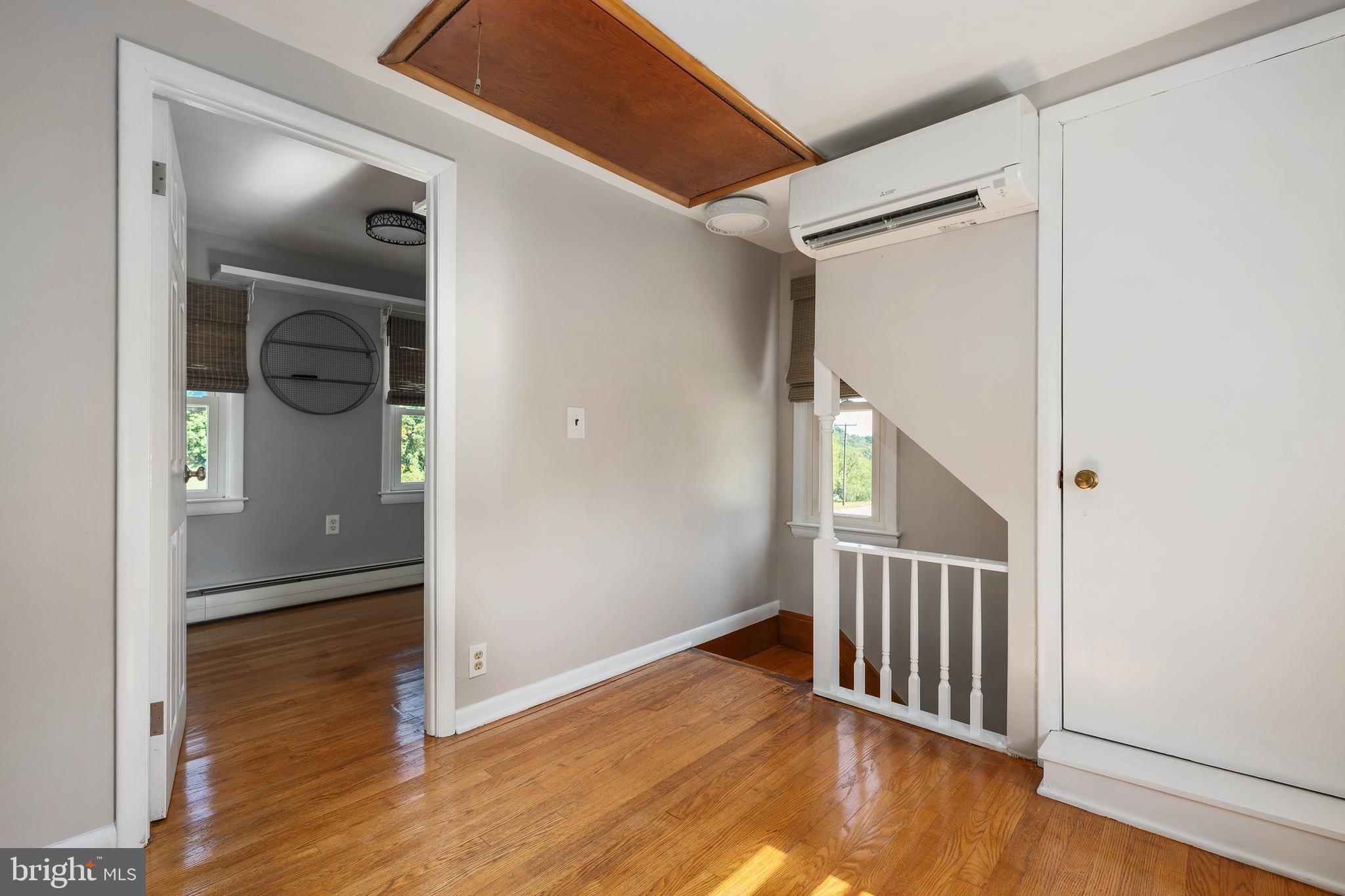 16357 Trenton Road Upperco, MD 21155 - Photo 33 of 68 a view of a hallway with wooden floor and stairs