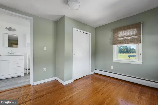 a view of a house with a big yard and large trees
