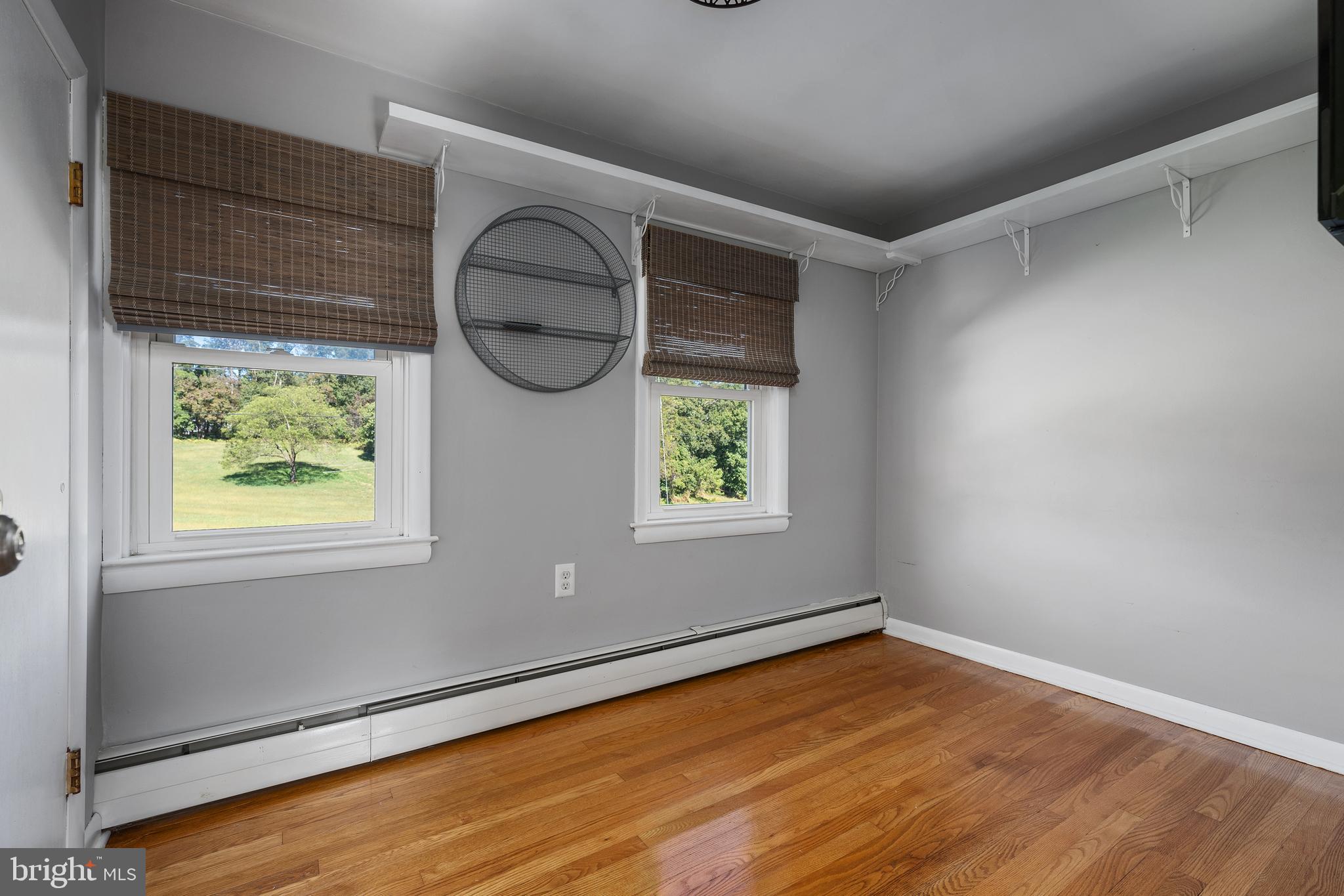 16357 Trenton Road Upperco, MD 21155 - Photo 39 of 68 an empty room with wooden floor and windows