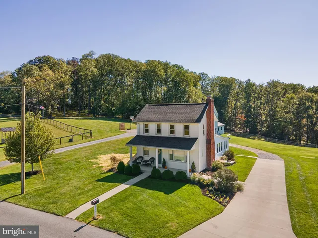 wooden floor fireplace and windows in an empty room
