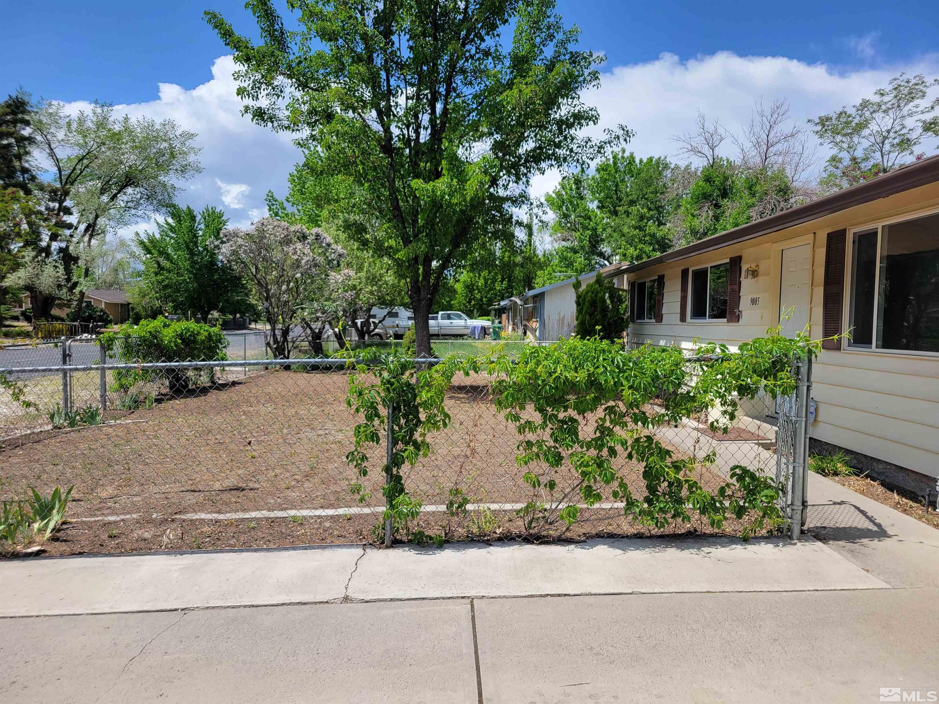 9085 Fremont Way Reno, NV 89506 - Photo 2 of 10 front view of a house with potted plants and a large tree