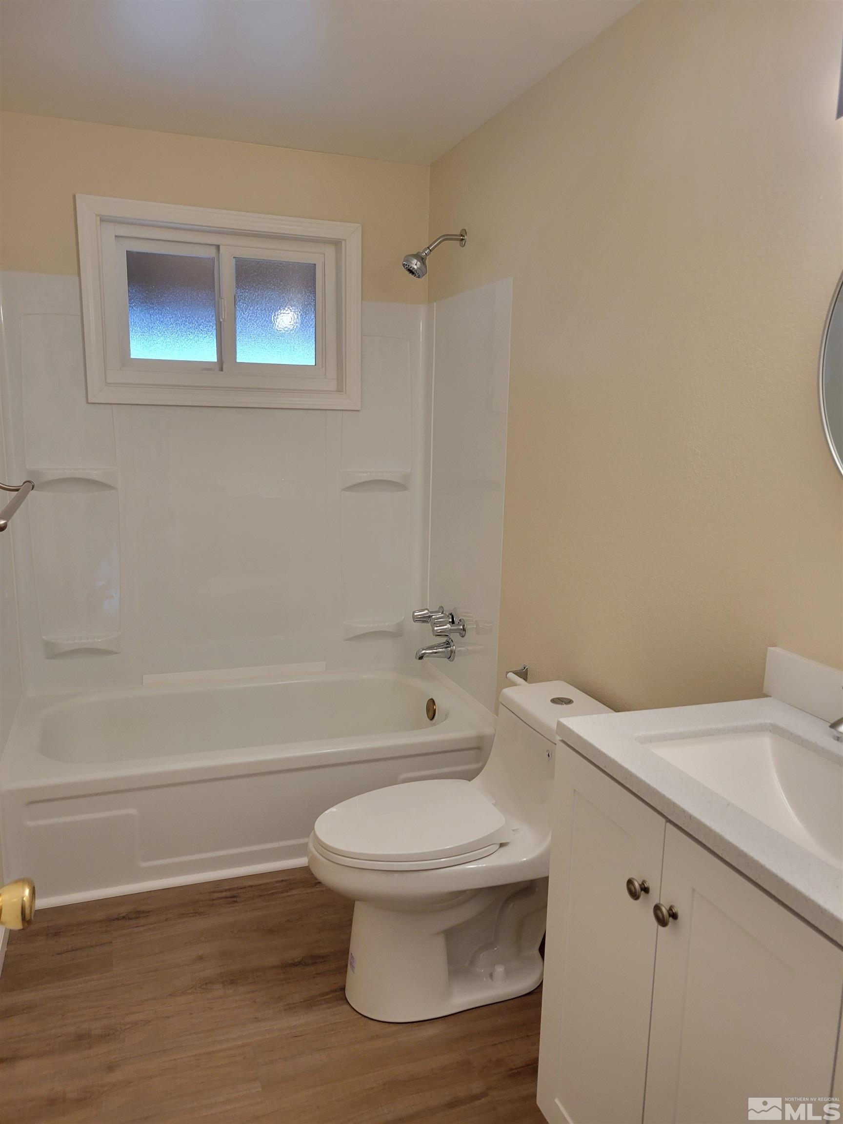 9085 Fremont Way Reno, NV 89506 - Photo 5 of 10 a bathroom with a toilet a sink and bathtub
