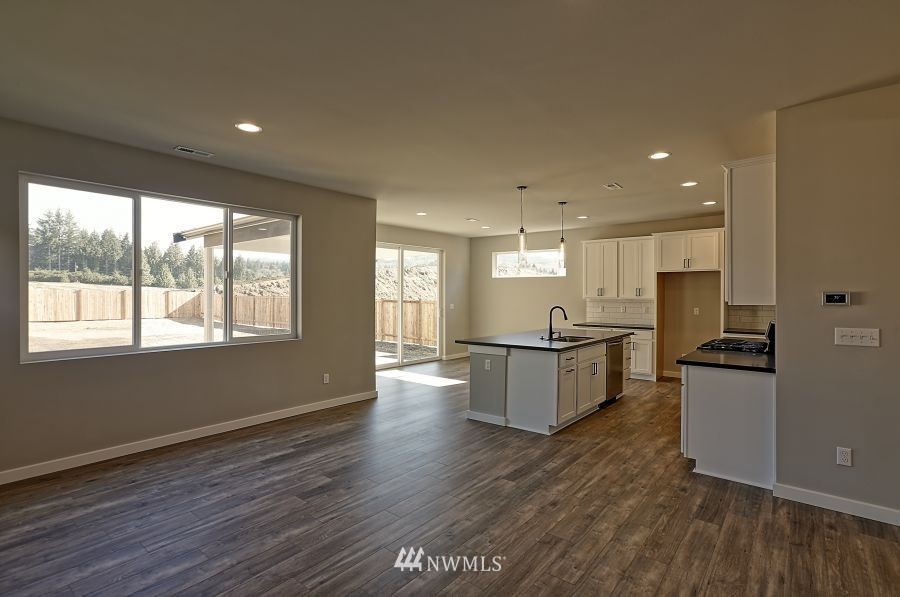 1007 Yew Avenue Sultan, WA 98294 - Photo 14 of 18 a large kitchen with stainless steel appliances granite countertop a lot of counter space and wooden floors