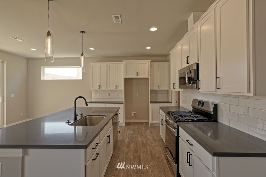 1007 Yew Avenue Sultan, WA 98294 - Photo 10 of 18 a kitchen with stainless steel appliances granite countertop a sink stove and refrigerator