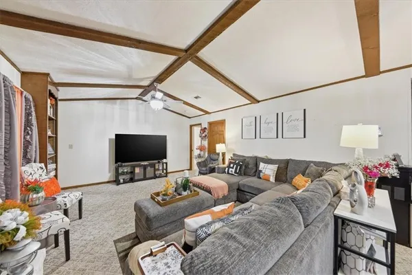 a living room with furniture and a chandelier