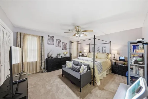 a bedroom with a bed and ceiling fan