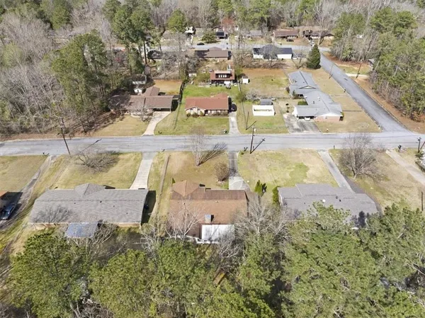 an aerial view of a house with a yard