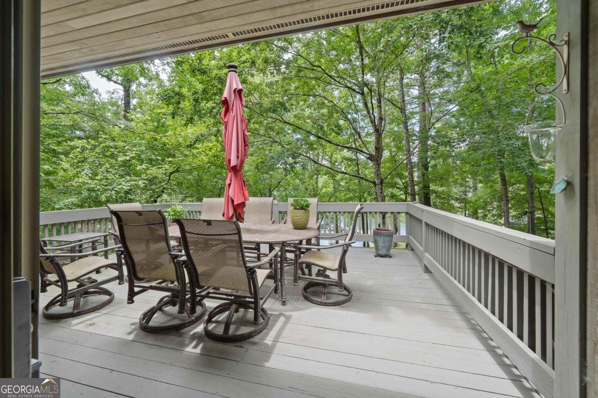 1031 Old Still Road Greensboro, GA 30642 - Photo 42 of 73 a view of a dining table and chairs on the roof deck