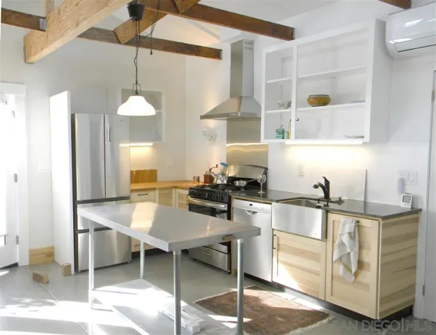a kitchen with a dining table chairs sink and stove