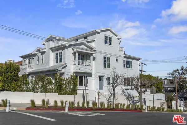 a view of a white building among the street and building