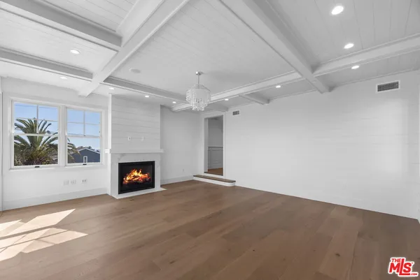 an empty room with a fireplace and fan