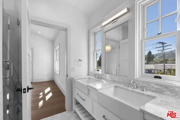 a bathroom with a granite countertop sink mirror and double