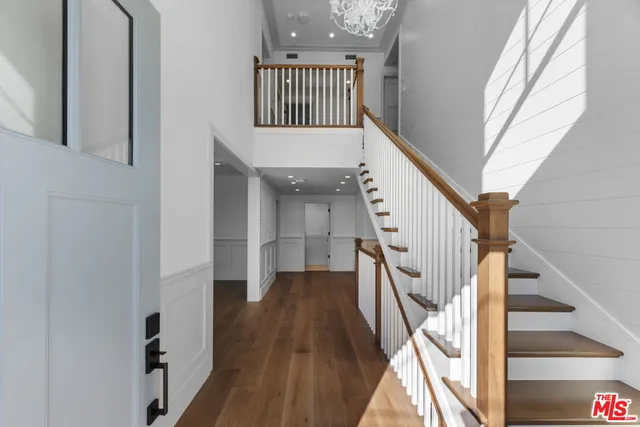 a view of entryway with wooden floor and stairs